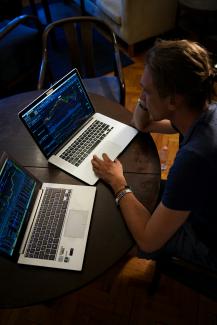 man sitting in front of the MacBook Pro by Adam Nowakowski courtesy of Unsplash.
