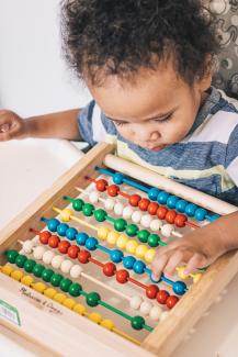 boy in blue and white floral shirt playing chess by luis arias courtesy of Unsplash.