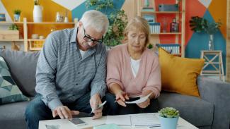 Elderly couple reviewing documents at home by Vitaly Gariev courtesy of Unsplash.