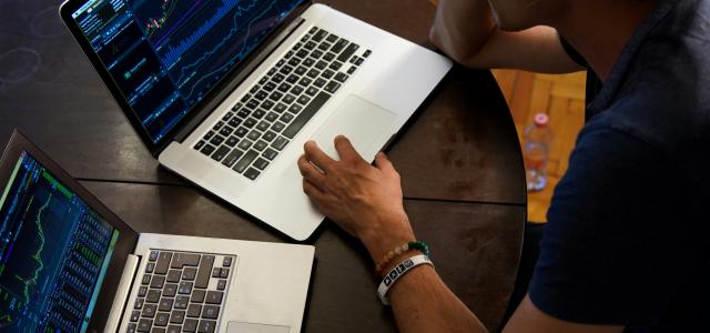 man sitting in front of the MacBook Pro by Adam Nowakowski courtesy of Unsplash.