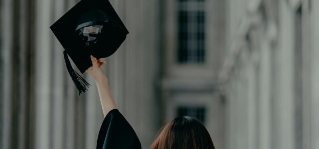 a woman in a graduation cap and gown by Albert Vincent Wu courtesy of Unsplash.